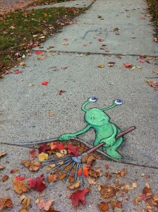 A green frog is drawn on the sidewalk.